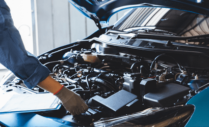 Mechaniker prüft offenen PKW-Motor in Autowerkstatt Delmenhorst